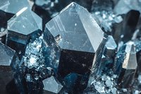 Macro shot of dark blue crystal formations with geometric shapes and natural facets showing mineral structure detail in cold tones. Suitable for geology and mineral studies.