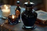 Vintage black glass jar with metal lid on wooden table with glowing candles and antique book in mystical dark atmosphere. Magical home decor setting.