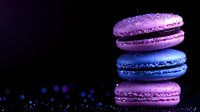 Colorful macarons stacked on dark background with bokeh effect. Purple and blue French macaroons with sparkles and glitter for luxury dessert presentation.