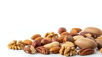 Mixed nuts assortment with almonds, walnuts, pecans and brazil nuts scattered on white background for healthy snacking and cooking recipes.