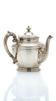 Antique silver teapot with ornate engravings and decorative handle isolated on white background for luxury dining and vintage collectibles.