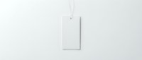 Blank white rectangular tag hanging from string against clean white background for branding mockup and product presentation design projects.