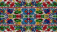 Traditional folk art floral embroidery pattern with colorful flowers and leaves on cream background, seamless design for textile and decorative applications.