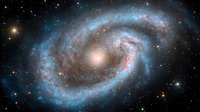 Majestic spiral galaxy with bright blue star-forming regions and glowing pink nebulae against dark space background, captured in stunning astronomical detail.