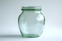Empty green glass jar with wide mouth and rounded shape on white background, suitable for preserves and storage. Minimalist composition with soft lighting.