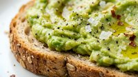 Avocado toast on multigrain bread topped with feta cheese, olive oil, black pepper and chili flakes. Healthy breakfast or snack concept for cafes and restaurants.