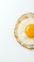 Crispy fried egg with golden yolk isolated on white background for breakfast menu design and culinary projects.