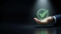 Businessman hand holding glowing green checkmark icon on dark background, representing approval, quality assurance, and successful business validation.