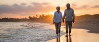 Senior couple walking hand in hand on beach at sunset, romantic golden hour moment by ocean waves, retirement lifestyle and love concept.