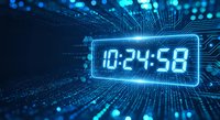 Digital clock display showing time 10:24:58 with glowing blue neon effect surrounded by futuristic circuit board patterns and data streams for tech concepts.