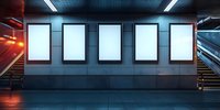 Five blank white illuminated advertising billboards on subway station wall with modern industrial interior and stairs in dark moody atmosphere.