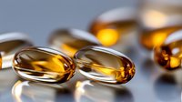 Translucent amber fish oil omega-3 gel capsules on reflective surface with soft lighting and shallow depth of field, highlighting nutritional supplement benefits.