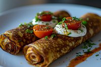 Savory crepes filled and topped with poached eggs, cherry tomatoes, and fresh herbs on white plate. Close-up with selective focus shows delicate texture and garnish.