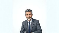 Mature male professional with gray hair and beard wearing dark gray business suit and navy tie, isolated on white background for corporate portraits, business presentations, and professional headshots.