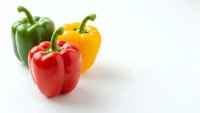 Fresh colorful bell peppers red yellow green isolated on white background for healthy cooking recipes and organic vegetable designs.