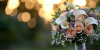 Wedding bouquet with peach roses and white calla lilies against blurred golden bokeh lights, featuring baby's breath and mixed greenery for romantic celebrations.