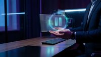 Businessman in dark suit holding glowing holographic pause button symbol above desk with keyboard in neon-lit modern office environment for technology and business concepts.