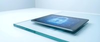 Modern tablet displaying digital data analytics dashboard with blue interface on clean glass surface for business technology presentations.