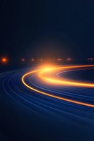 Glowing orange light trails curve along dark blue path at night, creating dynamic motion effect with illuminated streaks against deep background.