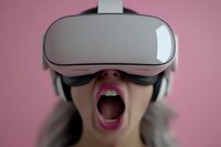 Young Asian woman wearing virtual reality headset with open mouth expressing amazement against pink background, modern technology concept.