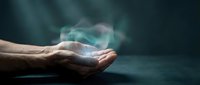 Open palm with glowing turquoise energy or light particles emerging, symbolizing healing, magic, spirituality, or power. Suitable for wellness, meditation, and alternative therapy concepts.