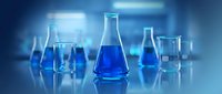 Laboratory glassware with blue chemical solutions in modern research facility. Scientific equipment for experiments and analysis in chemistry lab.