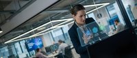 Professional businesswoman using holographic interface technology in modern office environment for digital transformation and innovation projects.