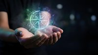 Hands holding glowing digital compass and navigation symbols with holographic light effects, representing technology, direction, and future innovation concepts.