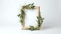 Wooden frame decorated with fresh green foliage, white flowers and natural branches on white background. Perfect for wedding invitations, greeting cards and botanical design projects.
