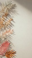 Dried palm leaves in pastel colors casting shadows on beige wall, creating minimalist botanical composition for modern interior design.