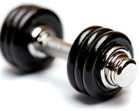 Black metal dumbbell with chrome handle on white background, shallow depth of field macro photography highlighting fitness and strength training equipment.