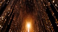 Glowing golden light streams through magical curtain of sparkling string lights creating dreamy tunnel effect with warm bokeh and depth perspective.