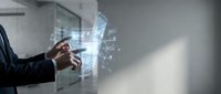 Businessman using futuristic holographic interface technology with digital data visualization and network connections in modern office environment.