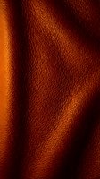 Burnt orange leather texture with natural grain and folds, suitable for fashion, upholstery, and design projects requiring authentic material backgrounds.