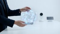 Businessman hands holding glowing holographic geometric sphere in modern office environment for technology and innovation concepts.