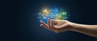Hand holding glowing digital icons representing business concepts including gears, scales of justice, and technology symbols on dark background.