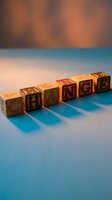 Wooden alphabet blocks spelling CHANGE on a blue surface with warm bokeh background, symbolizing growth, transformation, and new beginnings.