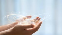 Hands holding glowing digital light particles and data streams, representing technology, innovation, and digital transformation for business and communication concepts.