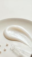 Creamy white skincare lotion texture with smooth application stroke on neutral background for beauty and cosmetic product advertising.