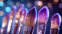 Makeup brushes with glitter sparkles against blurred bokeh background in purple and blue tones, close up macro shot showing soft bristles and shimmer details.