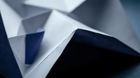 Abstract geometric composition with angular white and blue paper forms creating dramatic shadows and depth for modern design projects.