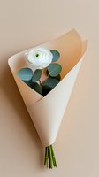 Single white ranunculus flower with eucalyptus leaves wrapped in minimal beige paper on neutral background, elegant floral arrangement for wedding or romantic gift.