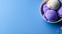 Purple and vanilla ice cream scoops in ceramic bowl on blue background with copy space. Fresh homemade frozen dessert for summer refreshment.