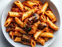 Penne pasta in rich tomato sauce with sauteed mushrooms and fresh herbs served on white ceramic plate, appetizing main course meal for restaurant menu.