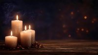 Glowing candles with rising smoke on rustic wooden table against dark background with bokeh lights, creating cozy atmospheric ambiance.
