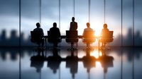 Business meeting silhouettes in modern conference room with city skyline view at sunset, corporate teamwork and leadership concept for presentations.