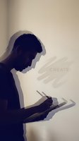Man using digital tablet, silhouette profile view with creative overlay text and brush stroke elements. Suitable for technology, design, and creative industry concepts.