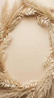 Dried pampas grass and leaf wreath frame on beige background with copy space for wedding, boho, or autumn seasonal design.