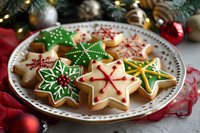 Star-shaped sugar cookies decorated with colorful royal icing in festive holiday designs on white plate with Christmas ornaments and pine branches in background.