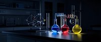 Laboratory glassware with colorful chemical solutions on dark table in modern research facility for scientific experiments and analysis.